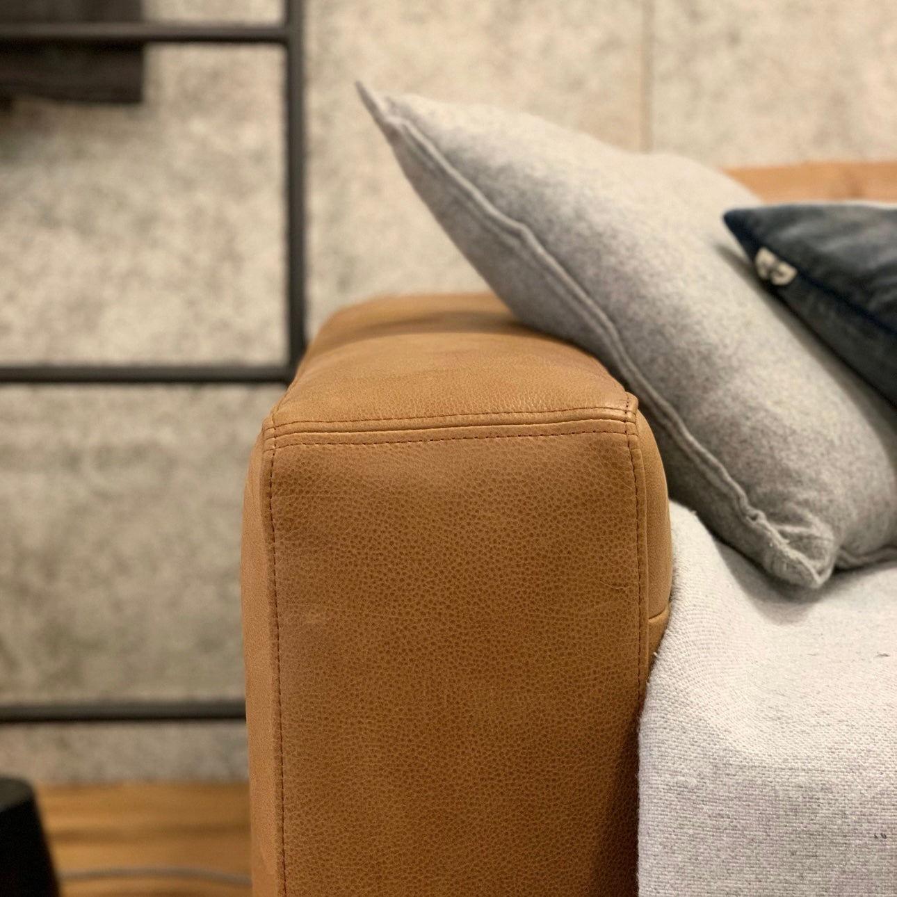    HALO FROSTER SOFAのアーム部分とクッションを寄りで写したレザー質感の画像